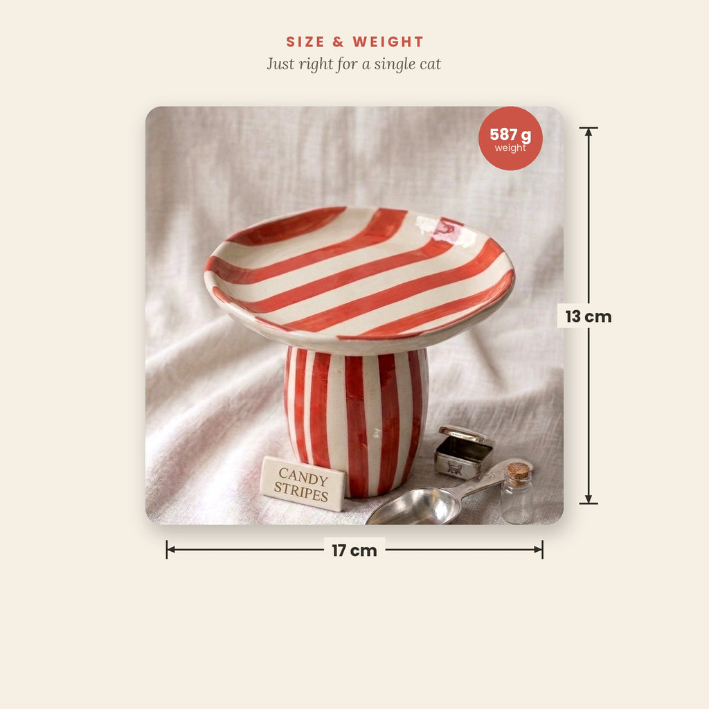 Red and white striped cat food bowl with measurements on a beige background